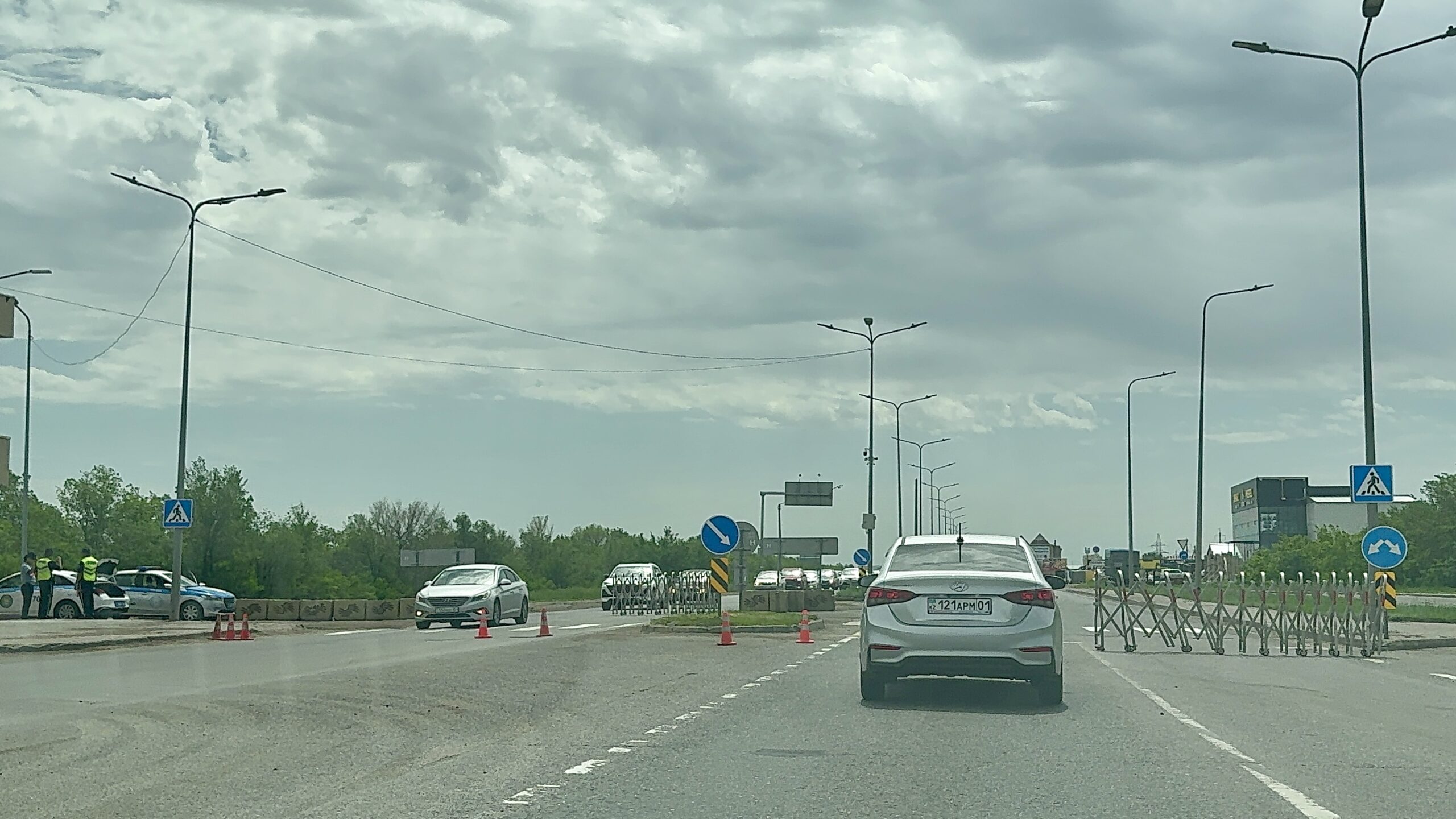 cars on a road with cars and a sign